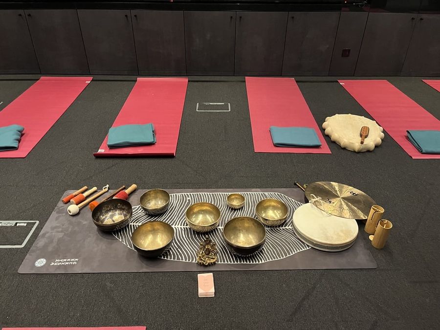 Singing bowls and mats laid out before a corporate sound bath