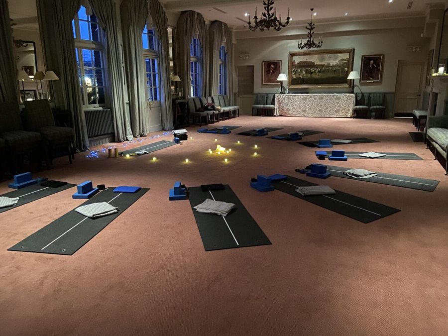A candlelit cacao ceremony set up in a panelled London hall